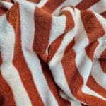Orange and brown striped looped terry knit fabric detail