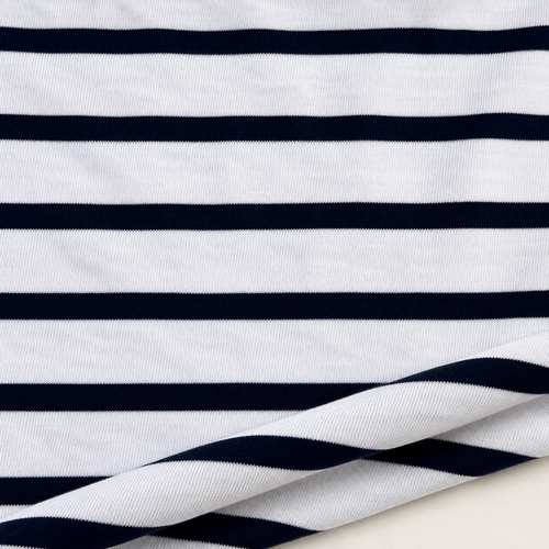 Styled product photograph of Striped Cotton Jersey Knit Fabric, Navy and White Stripe, 100% Cotton 144 GSM, Soft Drapey Apparel Fabric, Sold by the Yard. Original fabric photos follow.