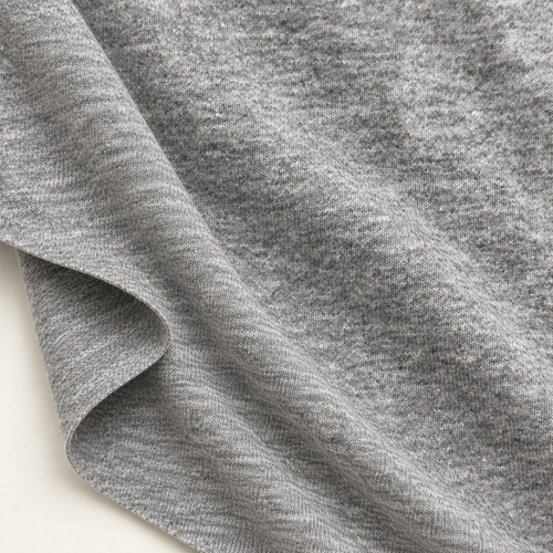 Styled product photograph of Heather Gray Cotton Jersey Knit Fabric, 100% Cotton 16/1 12 oz Midweight, Streetwear Tee Fabric, Sold by the Yard; original photographs follow.