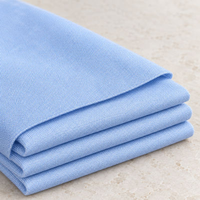 Styled product photograph of 58" 100% Cotton Pima Chambray 6 OZ Light Baby Blue Woven Fabric. Original fabric photos follow.