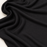 65" Modal Spandex Stretch Blend Piece Dyed Black Knit Fabric — styled fabric photograph
