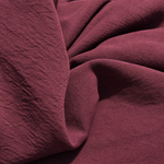 Burgundy — enzyme-washed Tencel Lyocell Gabardine — styled fabric photograph