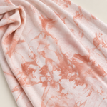 Peach bamboo spandex tie-dye jersey knit fabric, styled close-up
