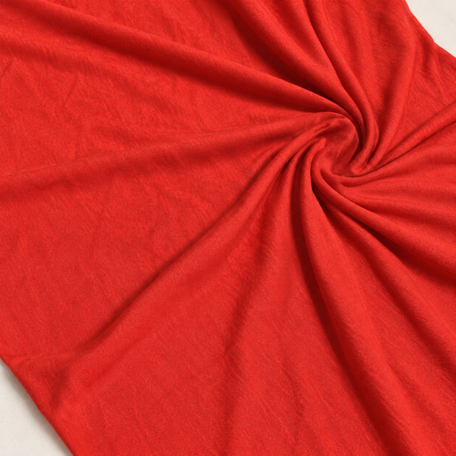 58" Red 100% Rayon Piece Dyed Jersey Knit Fabric By the Yard — styled fabric photograph