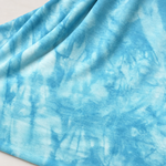 Sky Blue bamboo spandex tie-dye jersey knit fabric, styled close-up